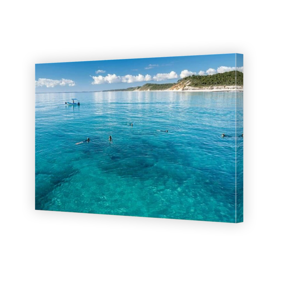 Tourists snorkeling in clear waters of Platypus Bay on West coast of Fraser Island, Hervey Bay, Queensland, Australia