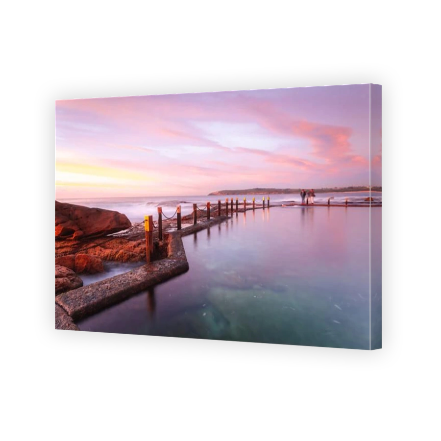 Serene pastel colours of early dawn morning light at Mahon ocean rock pool