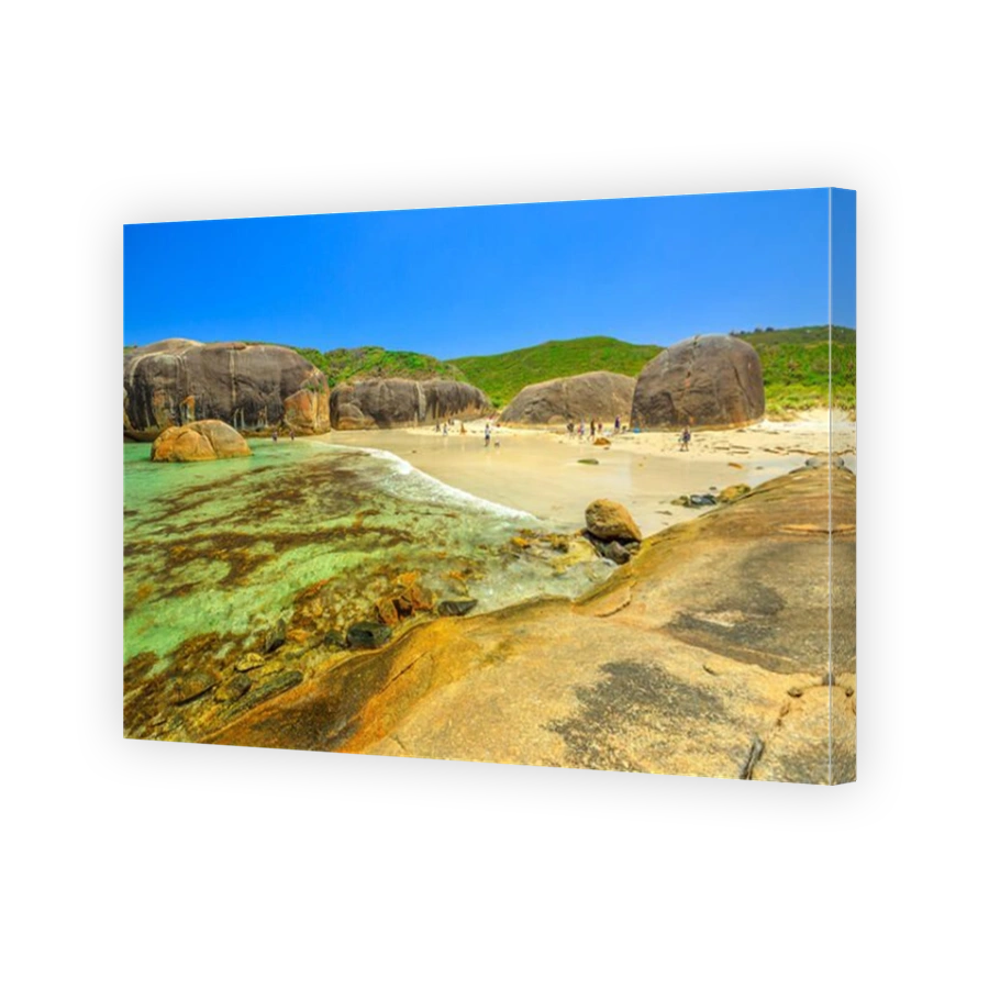 A view across Elephant Cove from eastern side of bay. People walking on shoreline of Elephant Cove Beach, William Bay National Park, Denmark, Western