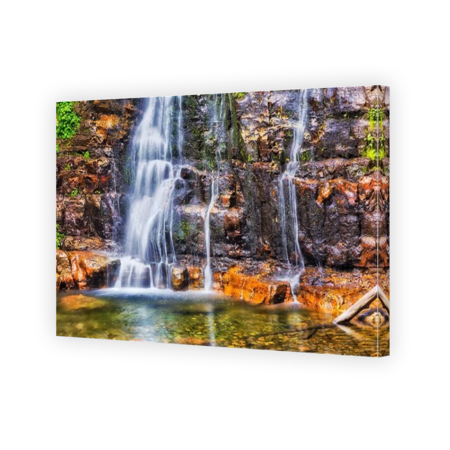 Part of Minnamurra falls flowding down from rocks in national part - bright vivid scenic view.