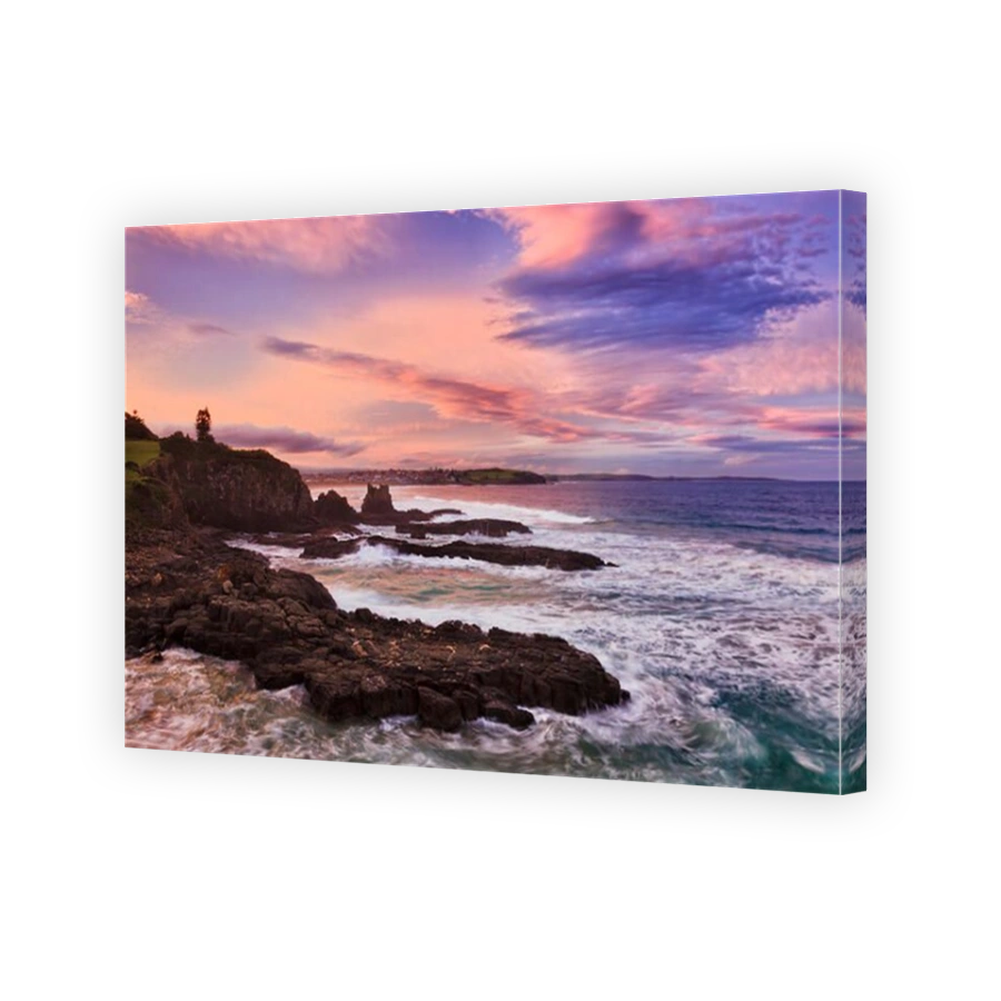 Colourful sunset over Australian pacific coast of Bombo Quarry cathedral rocks in Kiama.