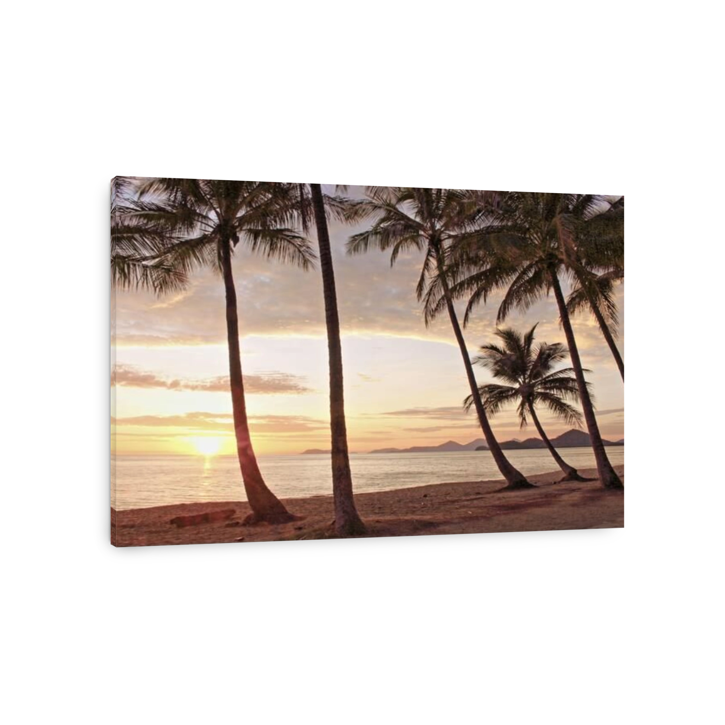 A hot sun rising over the Coral Sea off wet season Palm Cove beach