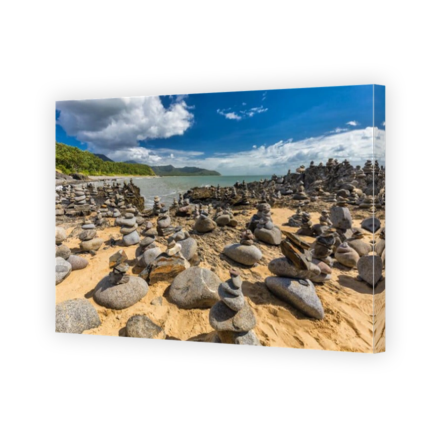 Stacked balancing rocks on the beach between Cairns and Port Douglas, Queensland, Australia