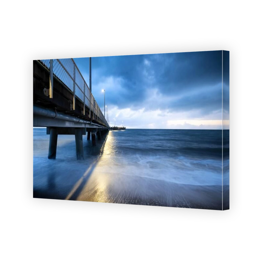 Beautiful shot of a metal pier near the ocean under cloudy sky at Cairns Cape Tribulation Australia