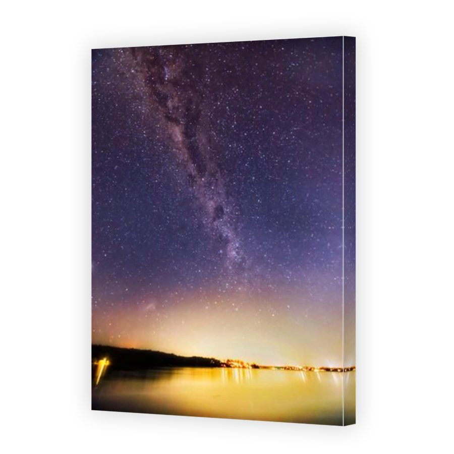 Bright Milky Way night sky constellation over still waters of Lake Macquarie in Australia - star gazing.