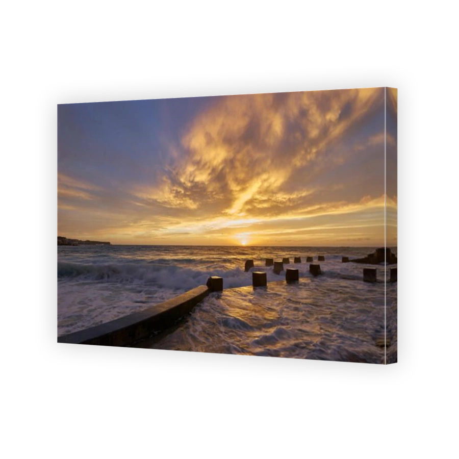 First lights of the day over a rock pool in Bronte beach, Sydney Australia