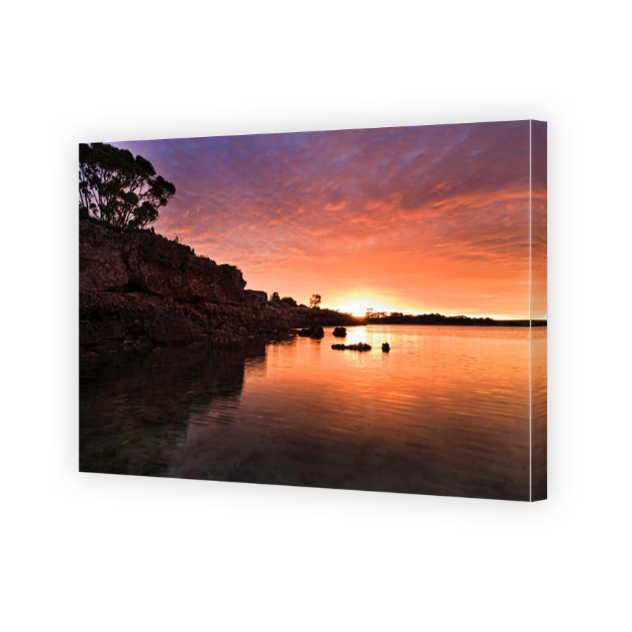 Colourful orange warm setting sun over horizon in West at Streaky Bay town on Great Australian Bight in South Australia.