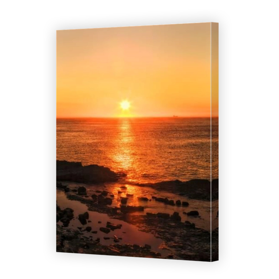 Colourful scenic sunrise of rising sun over Pacific ocean horizon from Swansea head in Austrlalia.