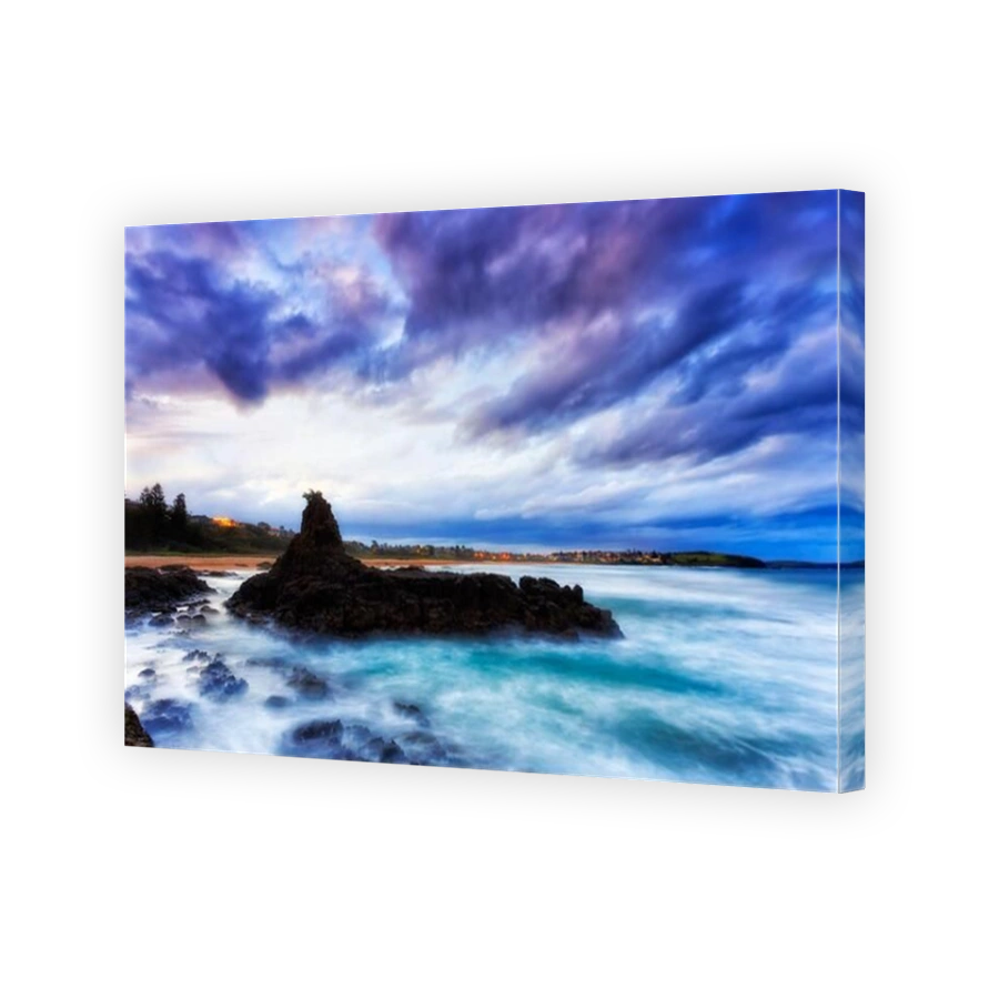Scenic sandstone and basalt rock formation off Bombo beach and Jones beach in Kiama of Australia - Pacific ocean seascape at sunset.
