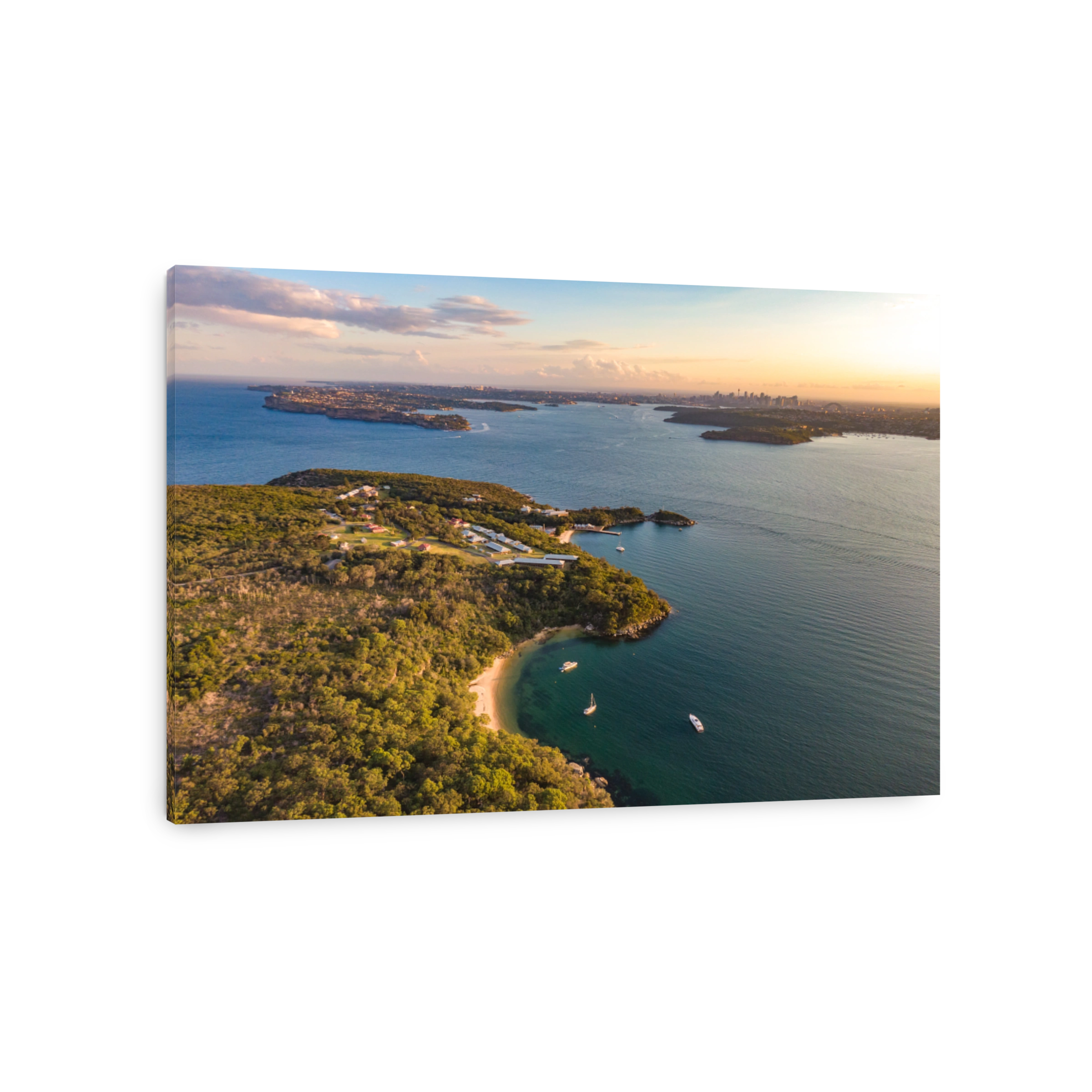 Aerial drone evening view of the Quarantine Station, part of Sydney Harbour National Park. Store Beach in foreground. Sydney harbour with North Head & South Head and city skyline in background.