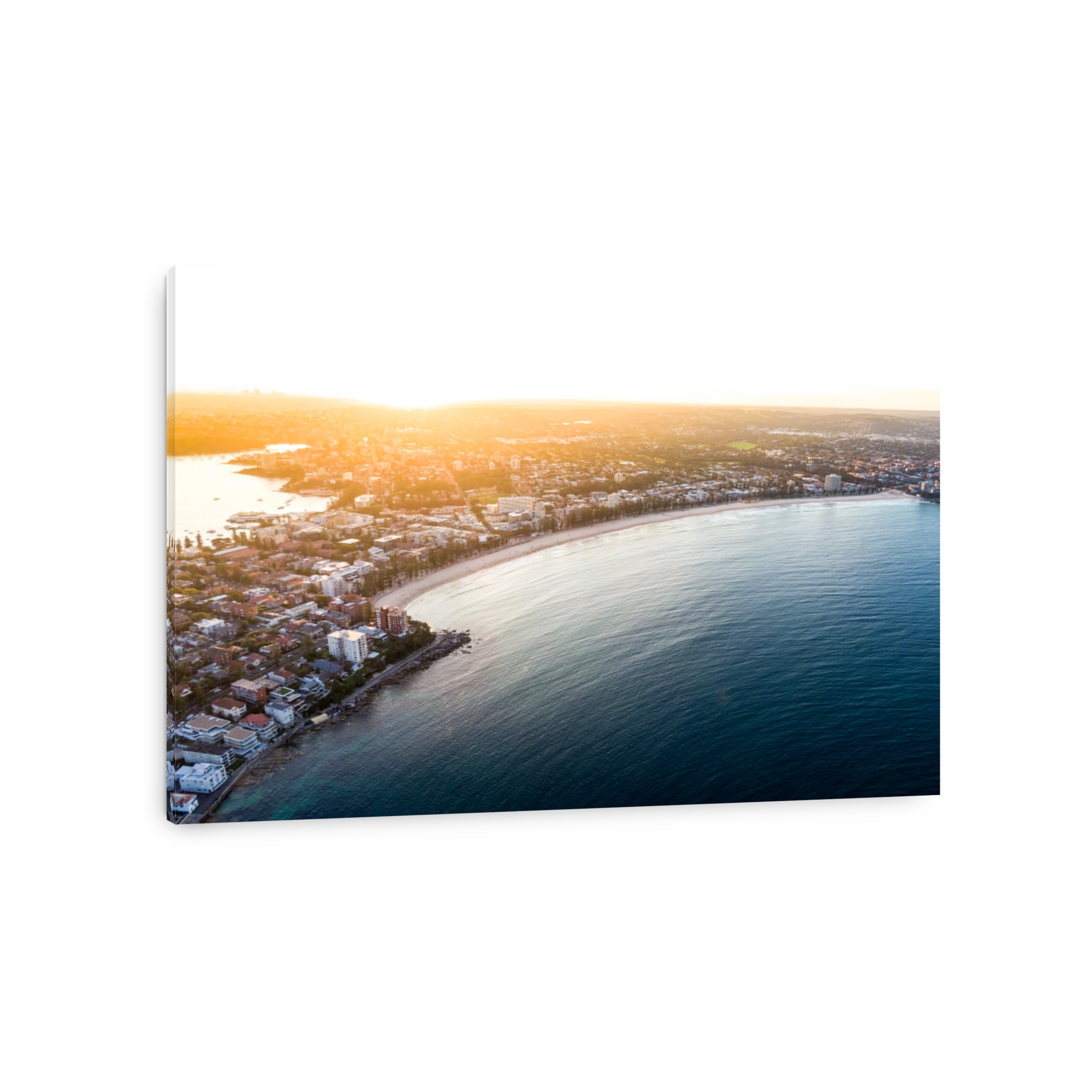 Aerial evening sunset drone shot of Manly, a beach-side suburb of northern Sydney, in the state of New South Wales, Australia. Famous Manly Beach in the foreground, a popular tourist destination.