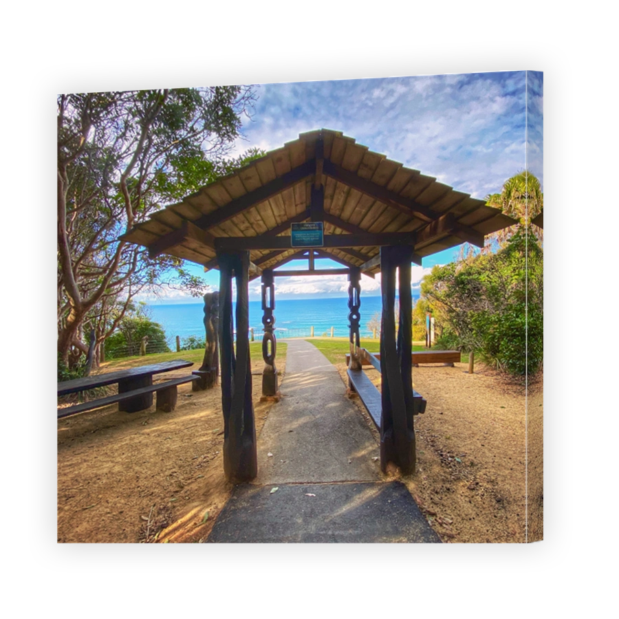 Hut house entry to the beach walkway to views of the blue ocean