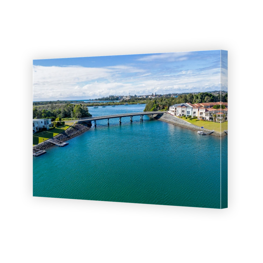 Aerial view of Hastings River and riverside Port Macquarie town in Australia under blue cloudy sky
