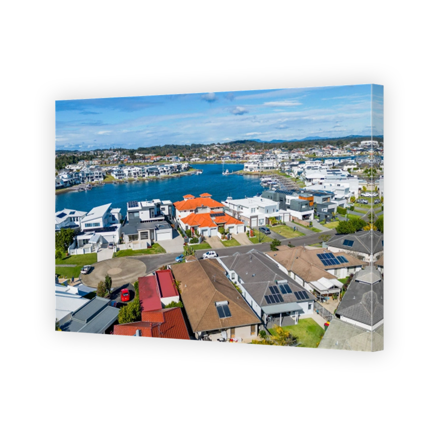 Aerial view of riverside Port Macquarie town in Australia and Hastings River under blue cloudy sky