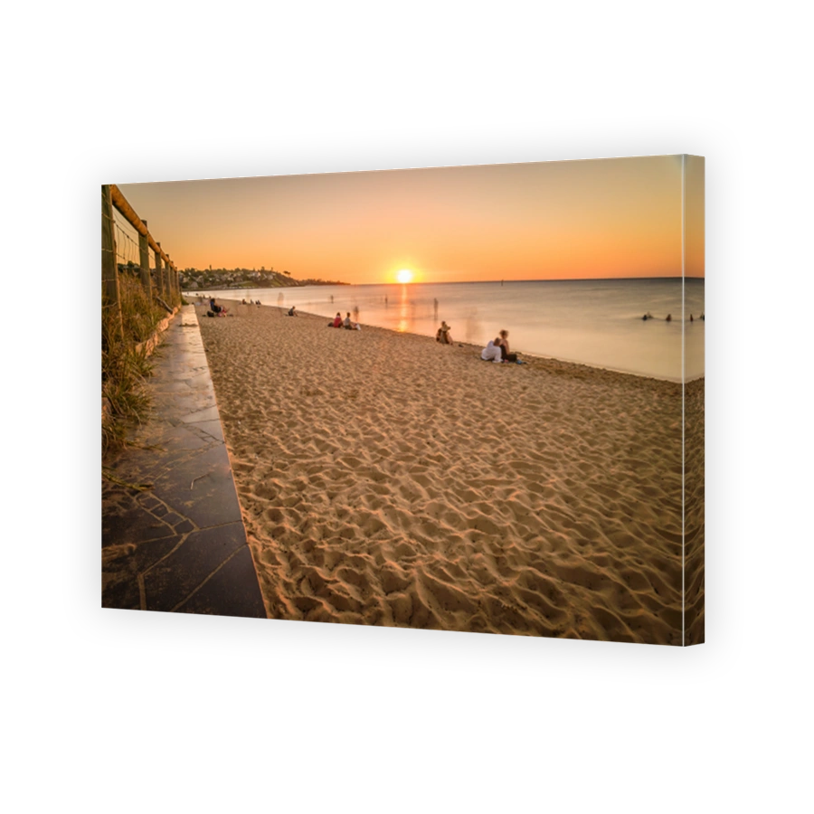 People watching the sunset at the beach in Frankston, Australia