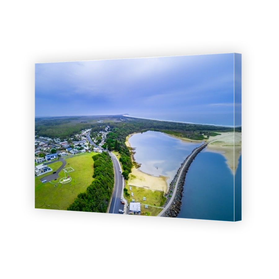 Aerial view of Harrington village, breakwater, and ocean coastline. Harrington, New South Wales, Australia