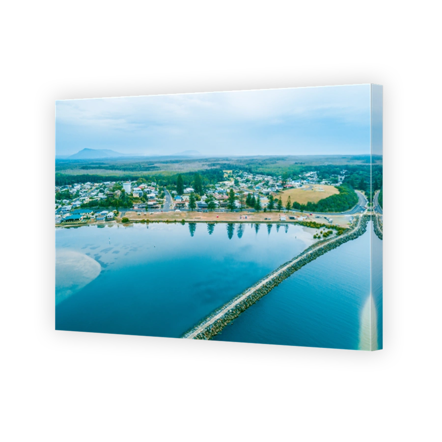 Aerial view of the long Harrington breakwall and township. Harrington, New South Wales, Australia