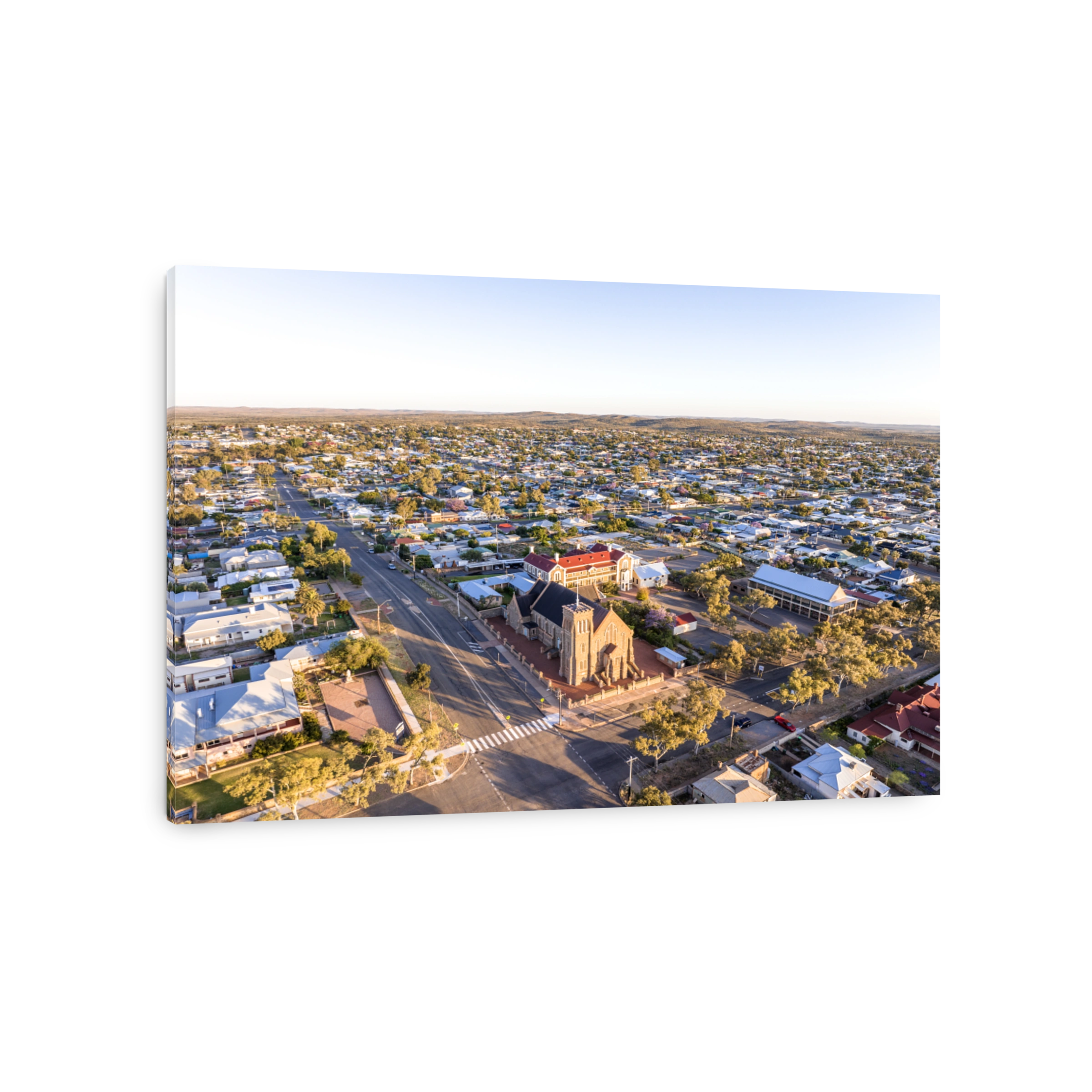 Early morning sunrise high angle aerial drone view of the Cathedral of the Sacred Heart of Jesus, a catholic church, and the historic outback mining town of Broken Hill, New South Wales, Australia.