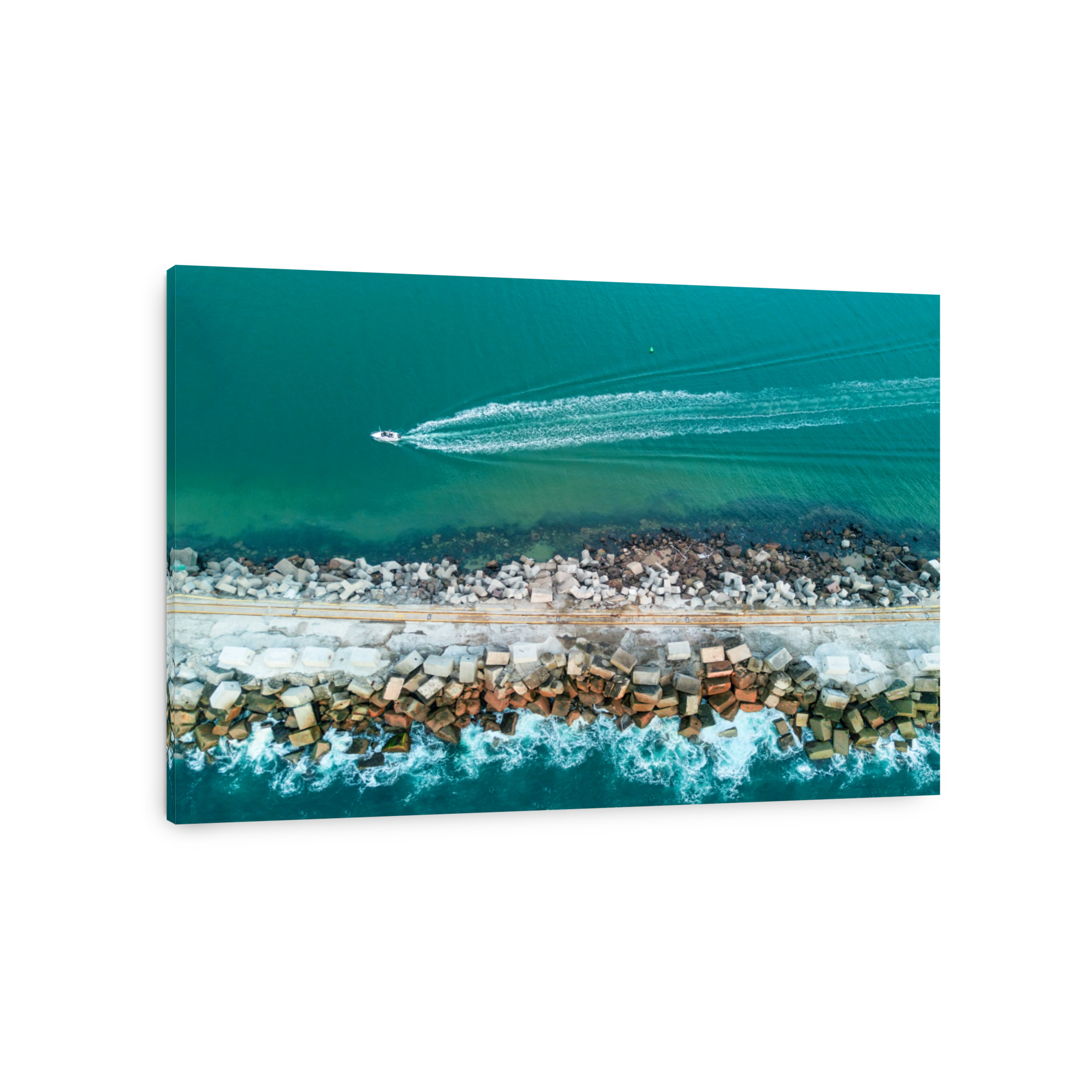 Speed boat motoring past a breakwall leaving a wake behind it