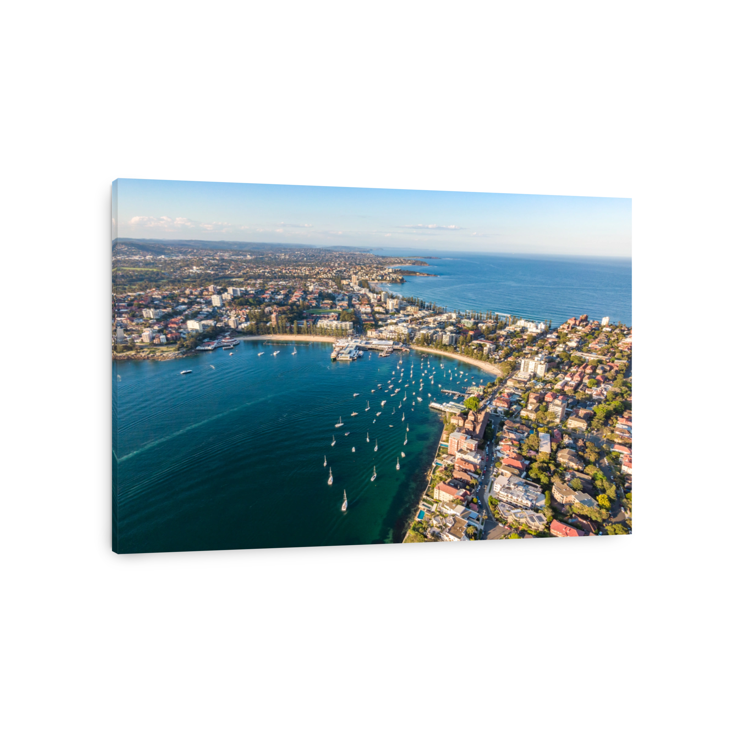 Aerial drone evening view of the Sydney suburb of Manly, a beach-side suburb of northern Sydney, in the state of New South Wales, Australia. Manly Harbour in the foreground, Manly Beach in the back.