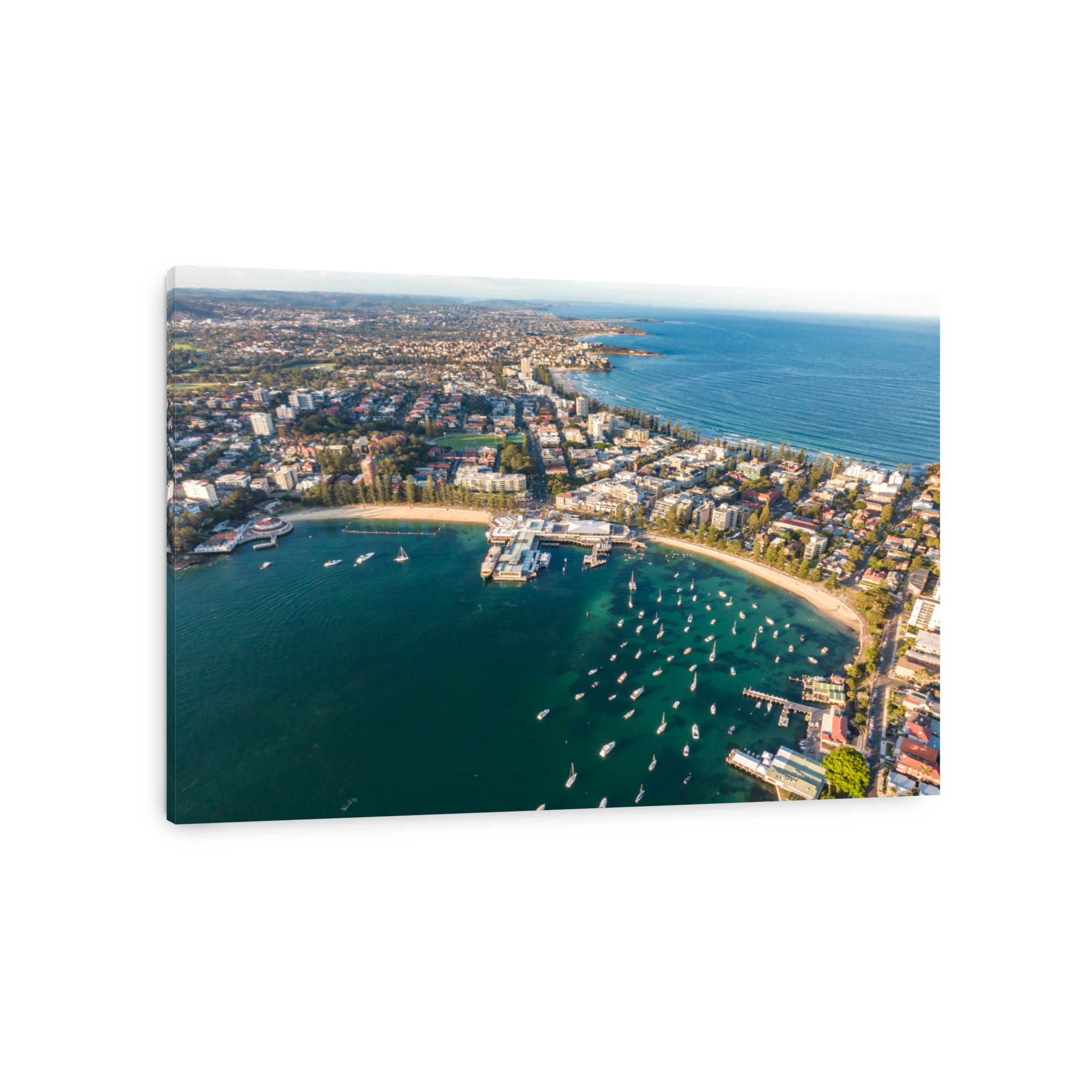 Aerial drone evening view of the Sydney suburb of Manly, a beach-side suburb of northern Sydney, in the state of New South Wales, Australia. Manly Harbour in the foreground, Manly Beach in the back.