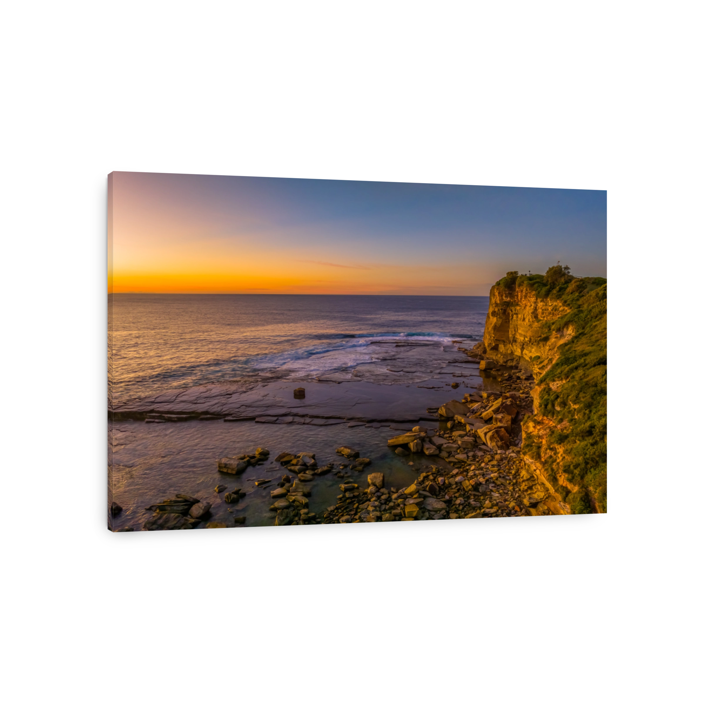 Sunrise over the calm sea and rocky Inlet