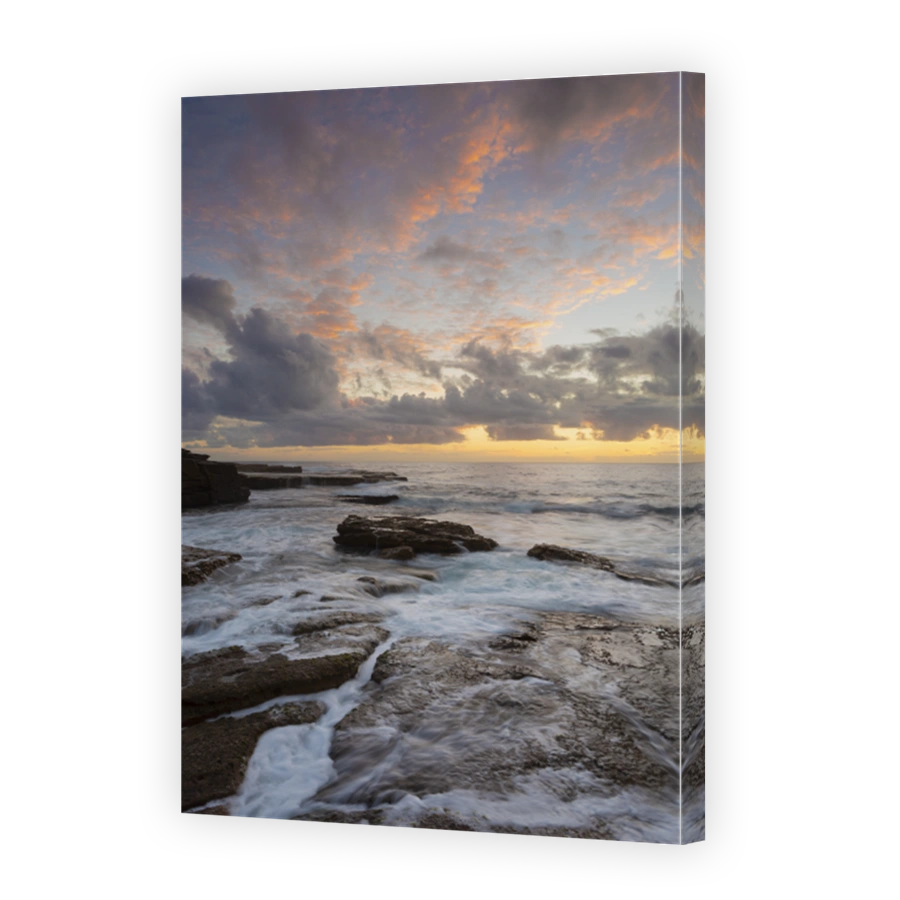 Sunrise over rocky ocean seascape
