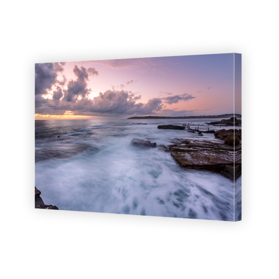 Beautiful dawn sky overlooking ocean and rock pool