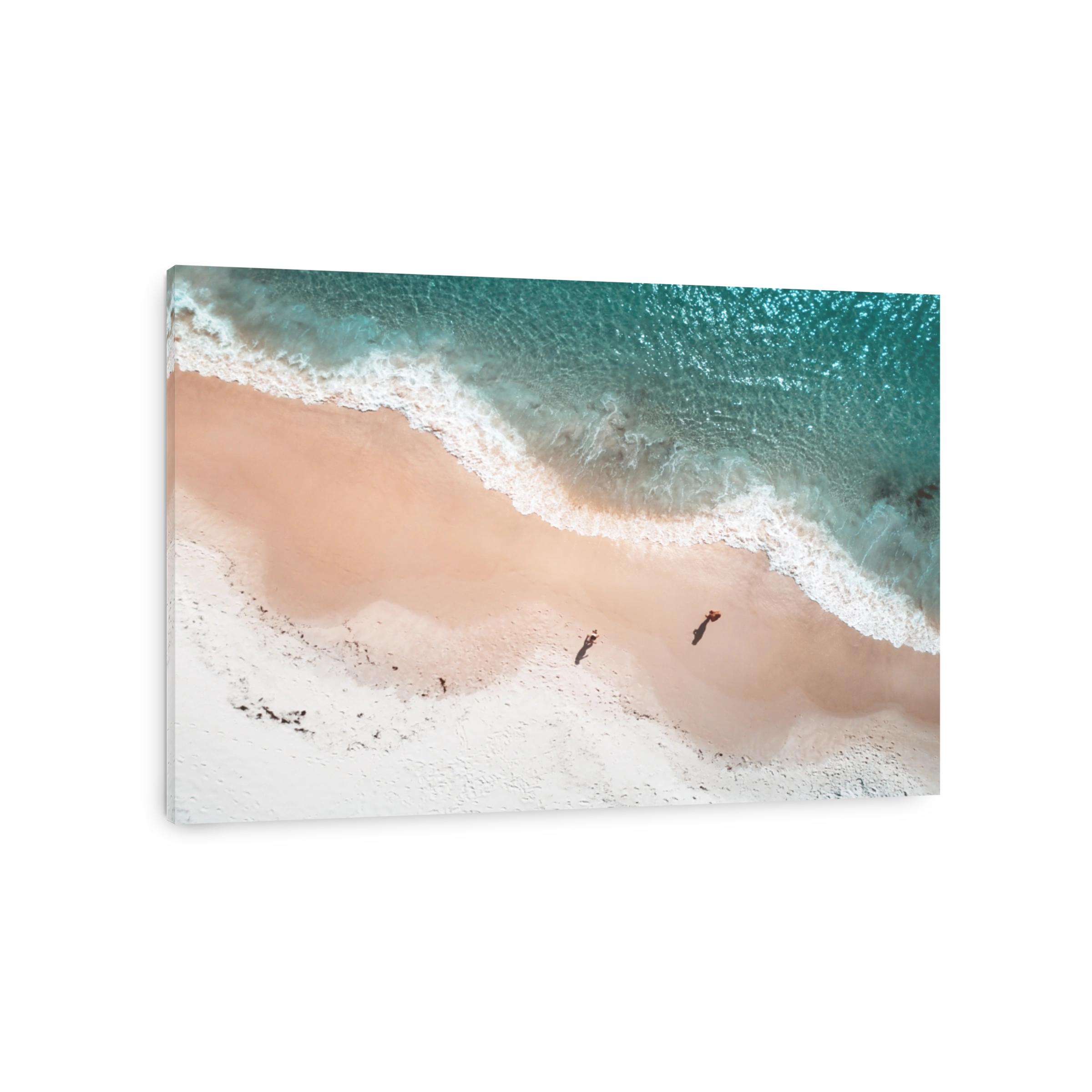 Aerial views of beach coastline with curving wave patterns