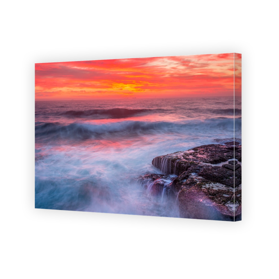 Red sunrise skies and ocean waves