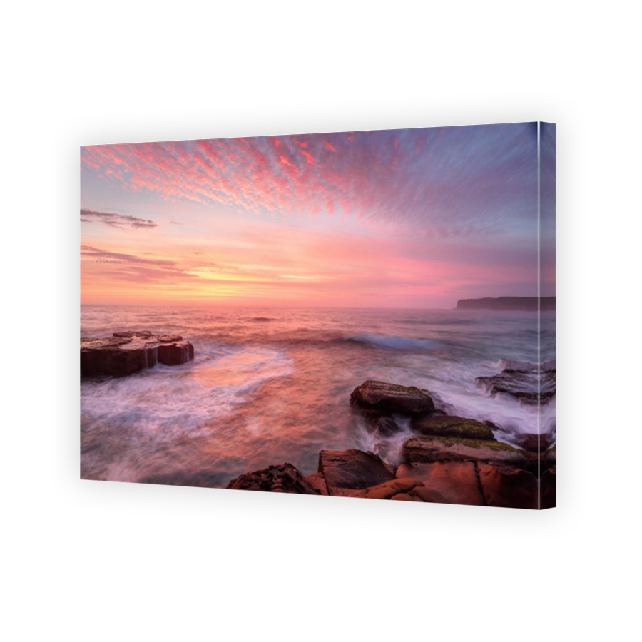 Sunrise skies and white water seas