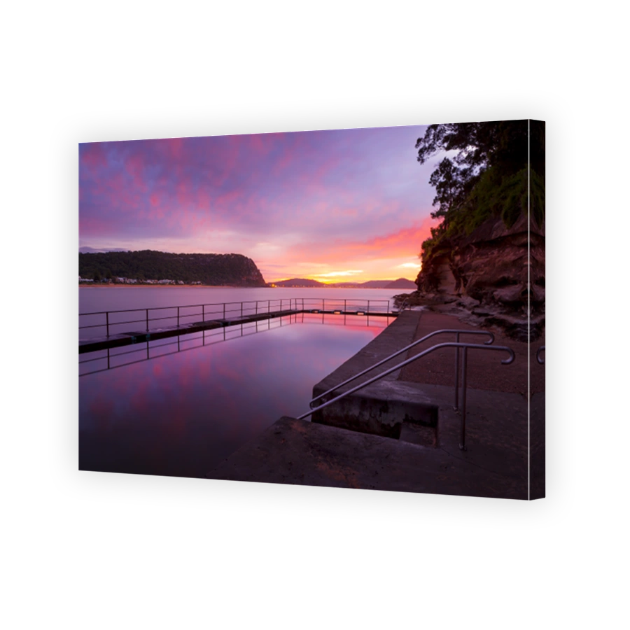 Red and pink dawn skies and beautiful reflections in the still waters of the rock pool