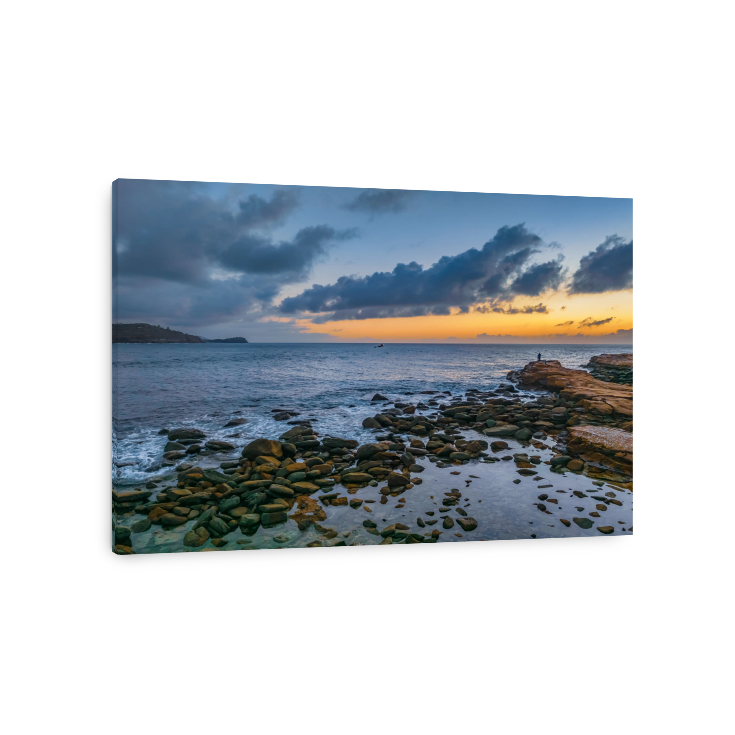 Moody morning at the seaside catching the sunrise with a cloud-filled sky