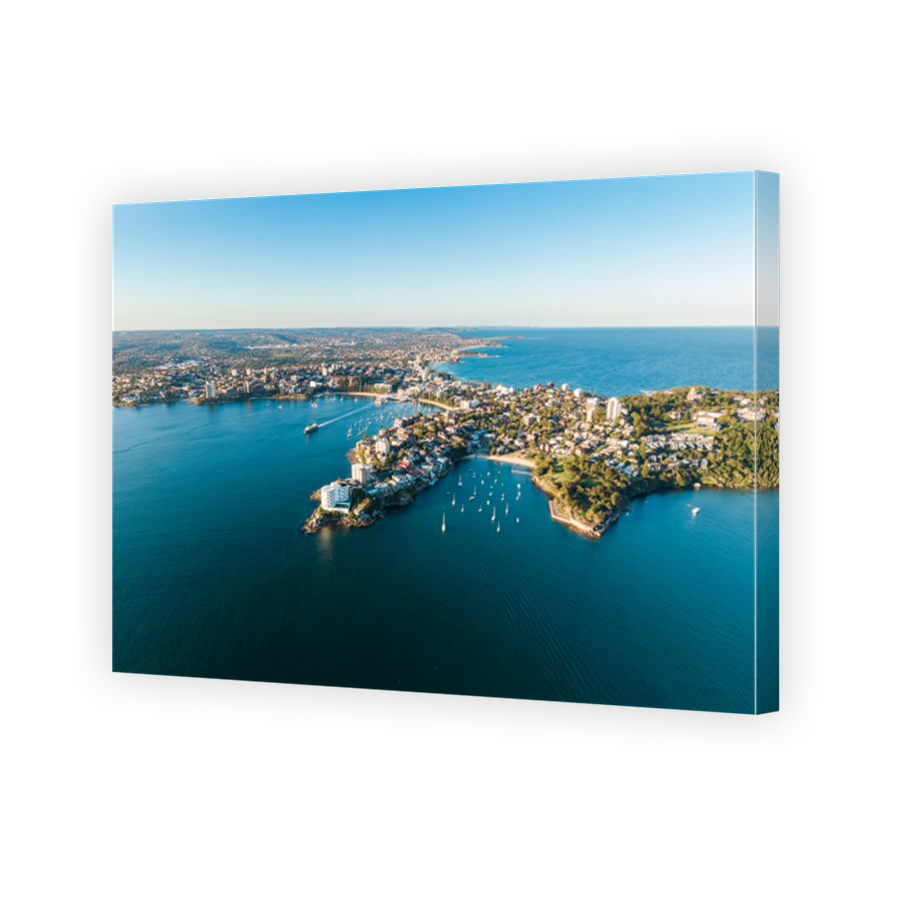 Aerial evening view of Manly, a suburb of northern Sydney in New South Wales, Australia. Little Manly & Collins Beach in the foreground, Manly Harbour, Manly Beach and Northern Beaches in background.