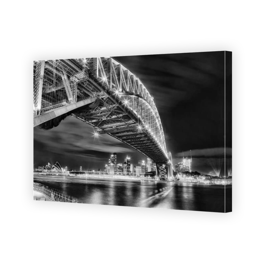Architectural landmarks of Sydney at dark during light show. Arch of Harbour Bridge above the head towards city CBD and Circular quay behind blurred w