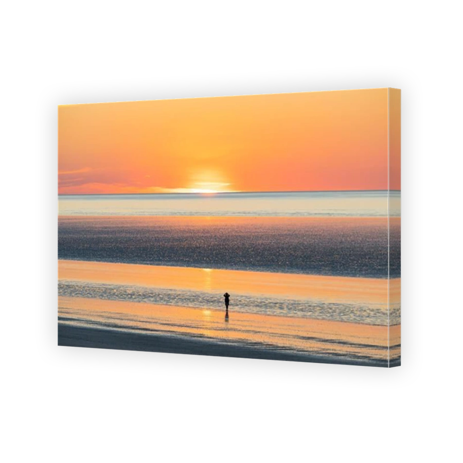 A lday is enjoying the beautiful view at 80 mile beach, in Broome, Western Australia