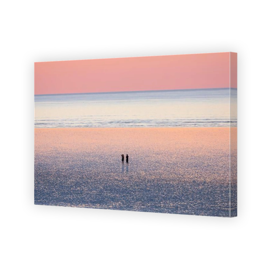 A couple are enjoying the beautiful sunset view at 80 mile beach, in Broome, Western Australia