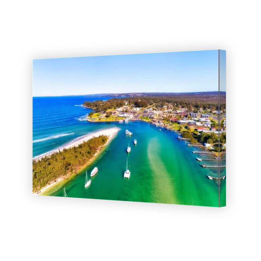 Rivermouth of CUrambene creek around Callala beach in front of Huskisson village on Jervis Bay of Australian Pacific coast - aerial view.