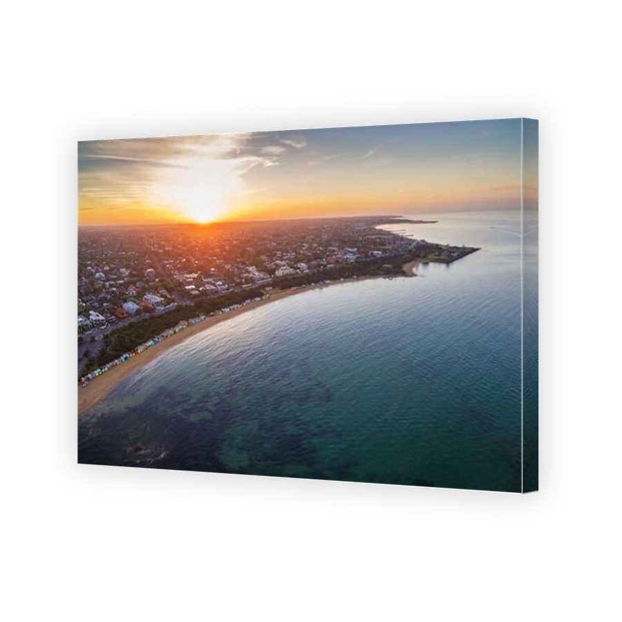 Aerial view of sunrise at Brighton Beach showing the suburb and bathing boxes. Melbourne, Victoria, Australia