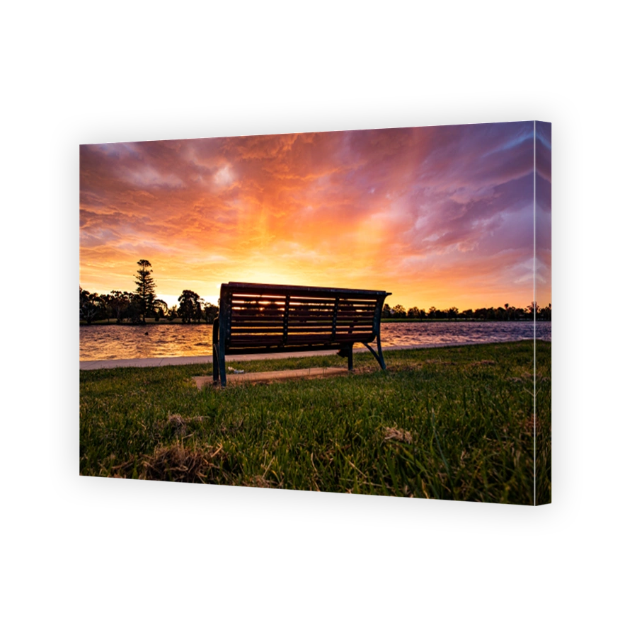 A lone chair under the rosy clouds and romantic sky in the sunset near the Albert Lake in Melbourne