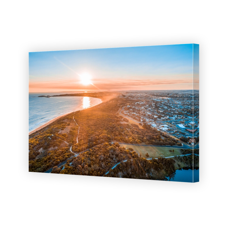 Sunset with sun flare over Warrnambool town and ocean in Australia