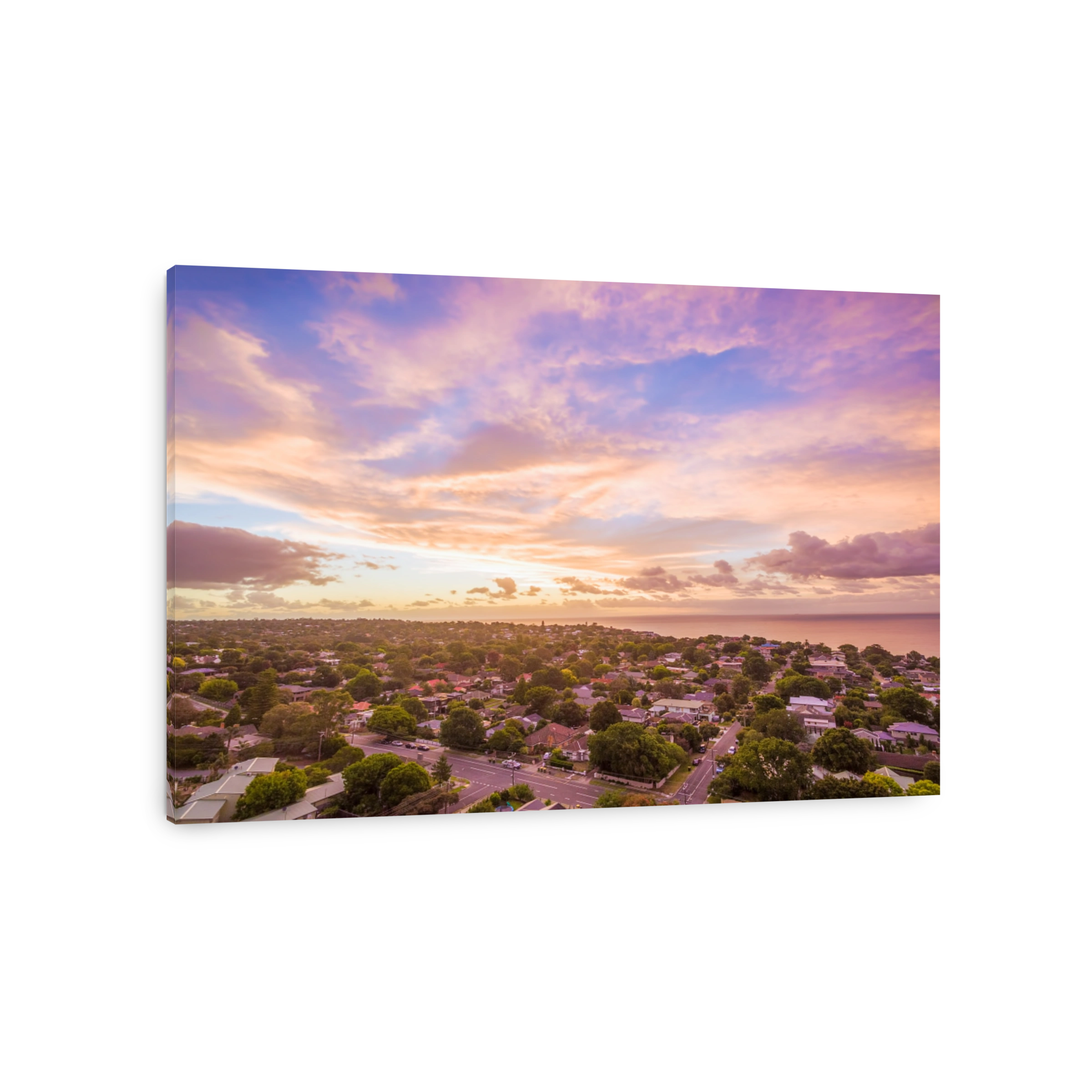 Aerial view of houses near coastline at beautiful sunset