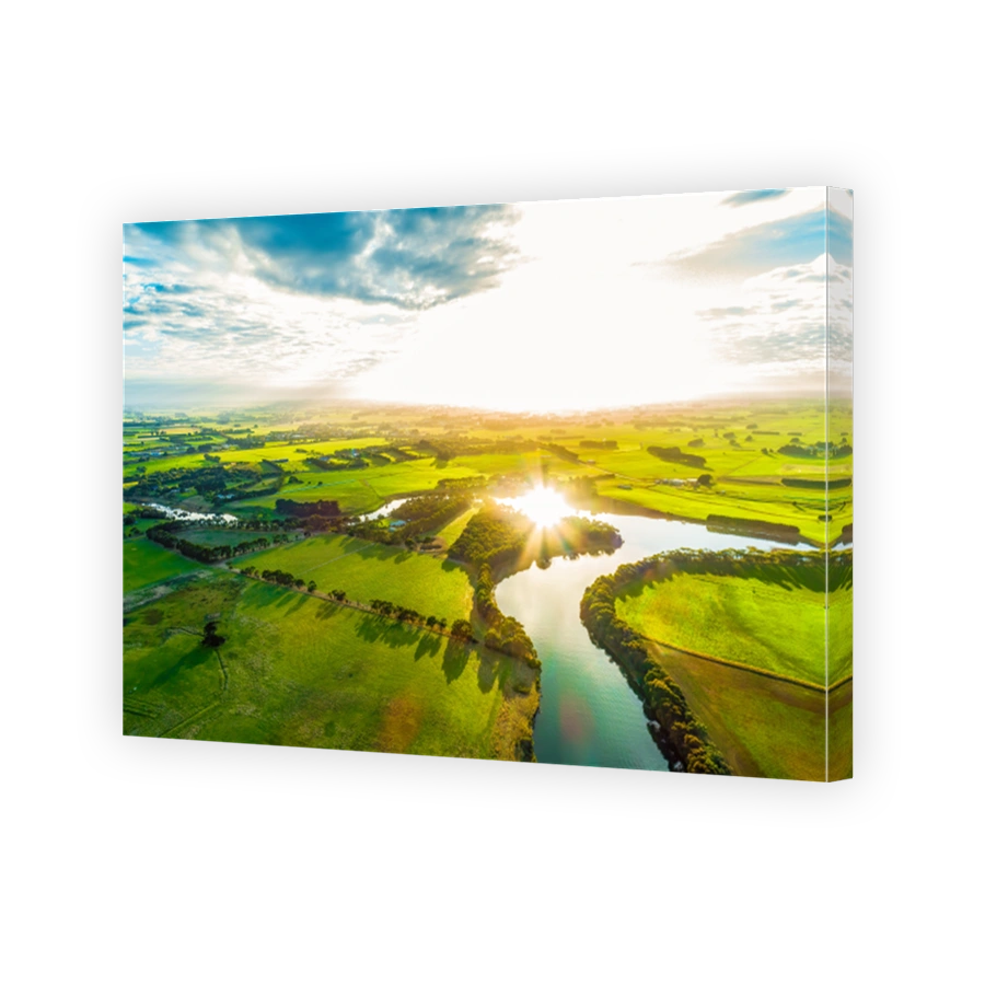 Bright sunset over scenic river in lush green countryside