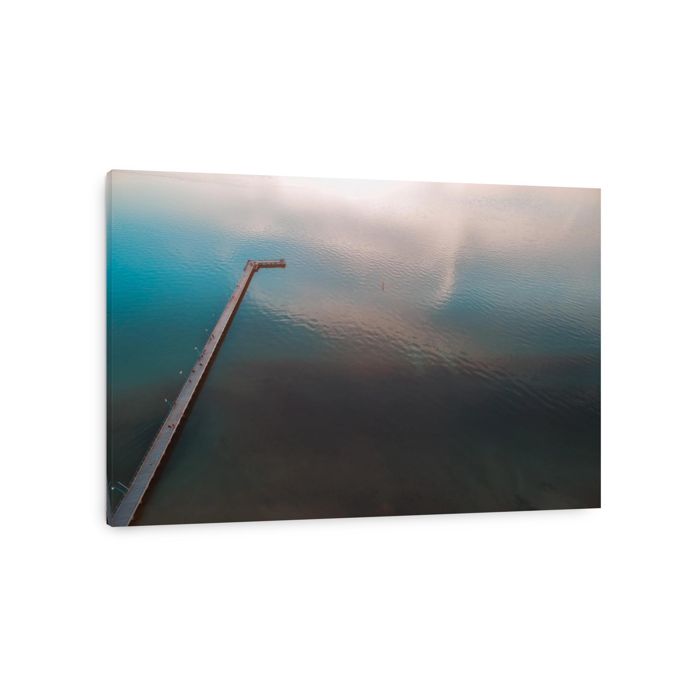 Long wooden pier and calm sea with cloud reflections - aerial view