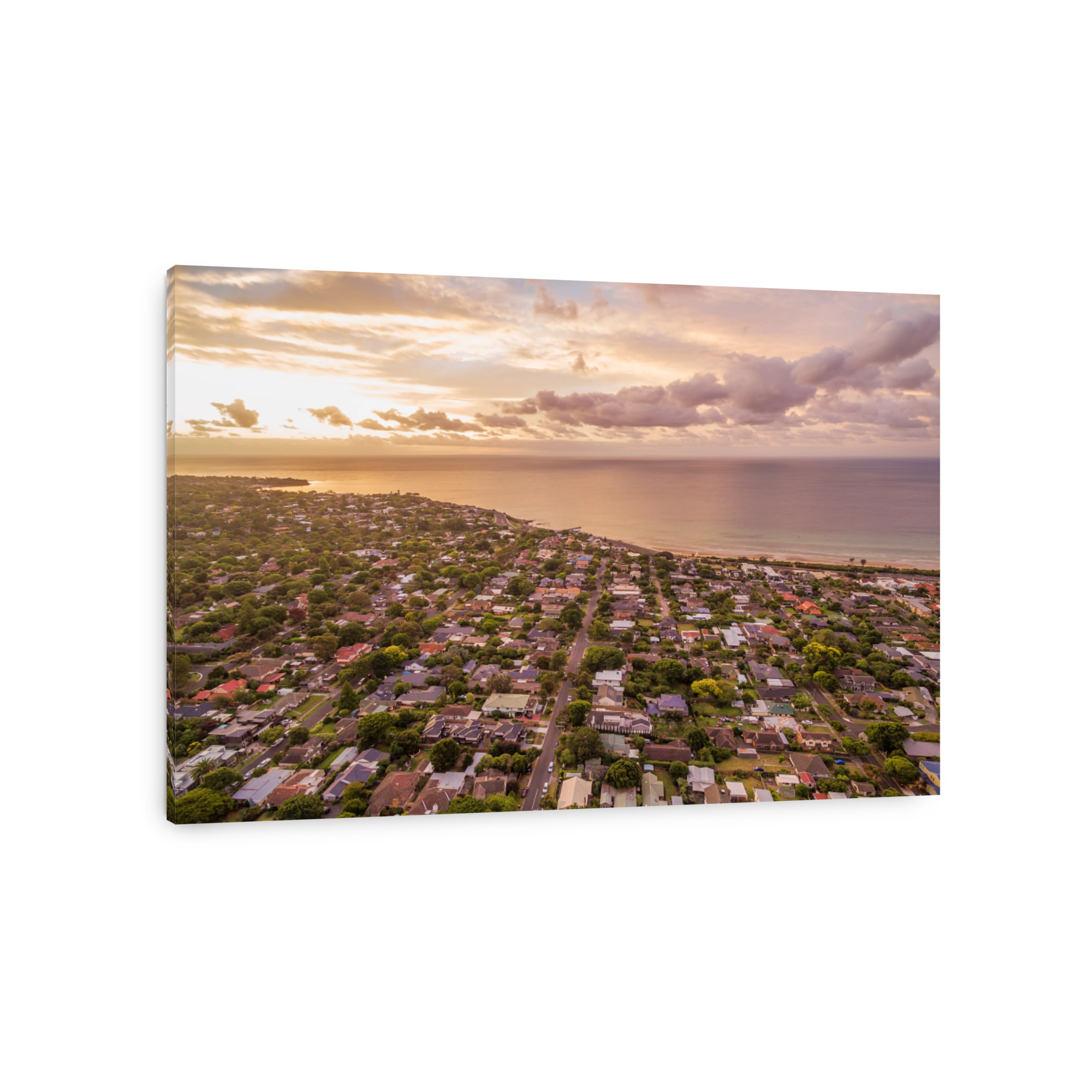 Aerial view of residential area near coastline at sunset