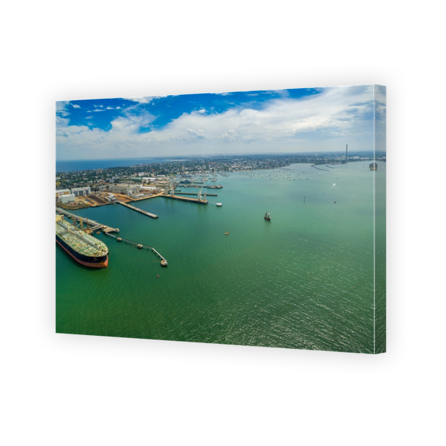 Aerial panorama of oil tanker moored at industrial port and Yarra river mouth. Williamstown, Victoria, Australia