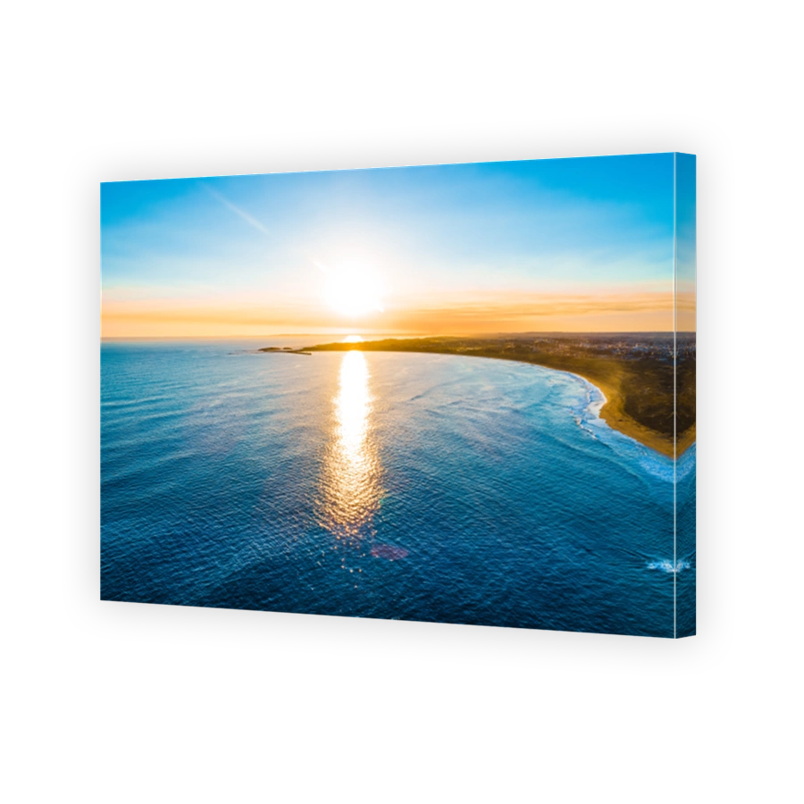 Aerial view of ocean coastline at sunset with copy space