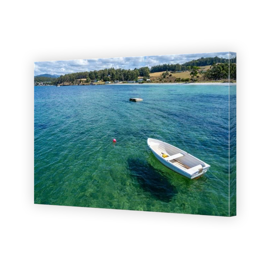 White dingy at anchor in clear water at Southport, Southern Tasmania