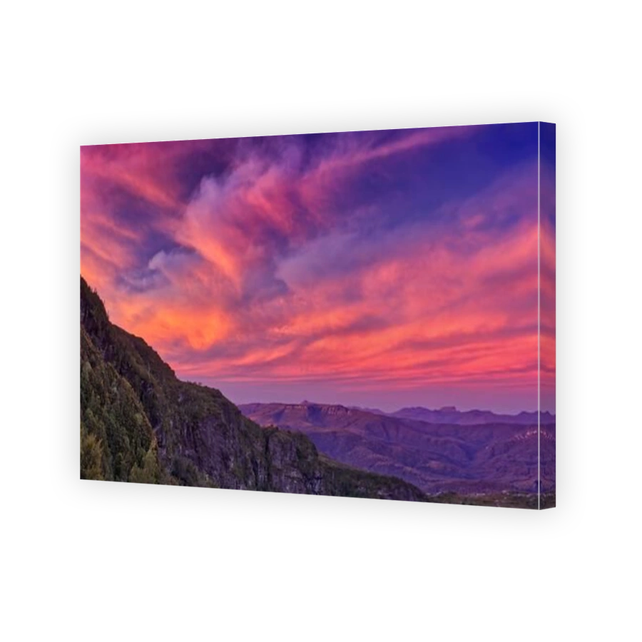 Pink and red lit clouds at sunset over the West Coast Range from Lake Tahune, Franklin-Gordon Wild Rivers National Park, Tasmania, Australia