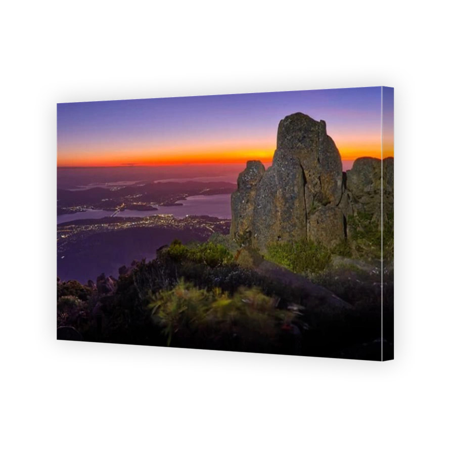 View of Hobart from Pinnacle observation shelter lookout on Mount Wellington at sunrise dawn with rocks clear sky orange horizon Tasmania, Australia